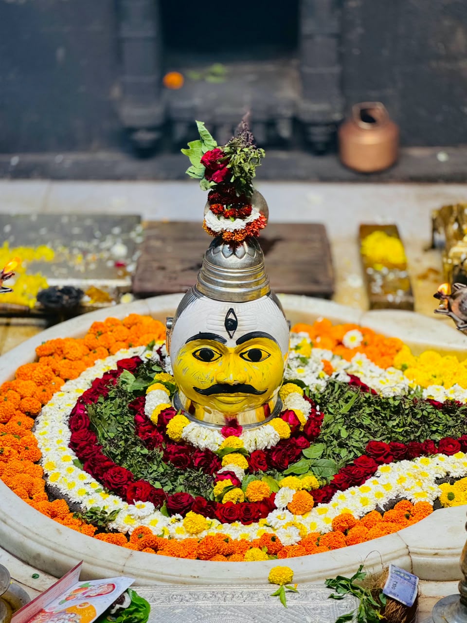 Sacred Shivalinga decorated with marigold, rose and bel patra garlands