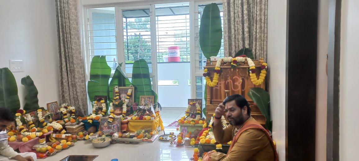 Home puja altar arranged with banana leaves and deity images