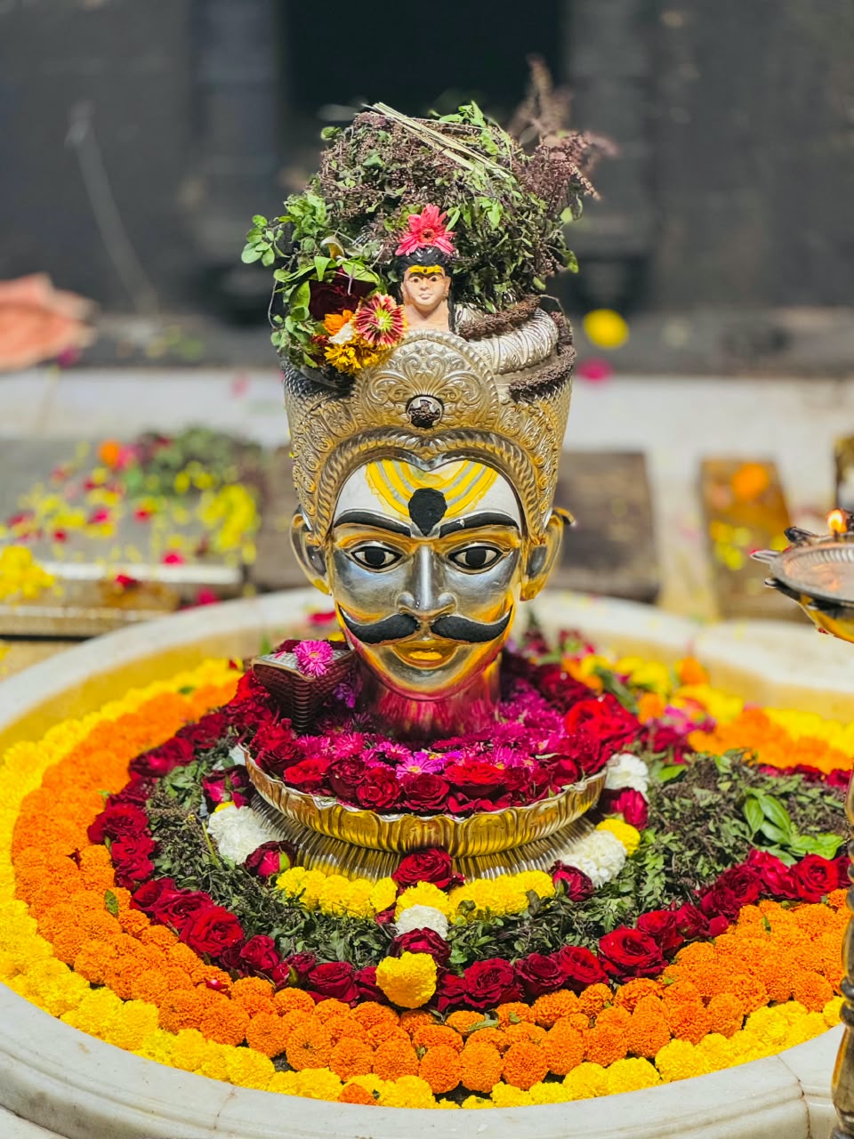 The crowned Jyotirlinga surrounded by vibrant floral offerings